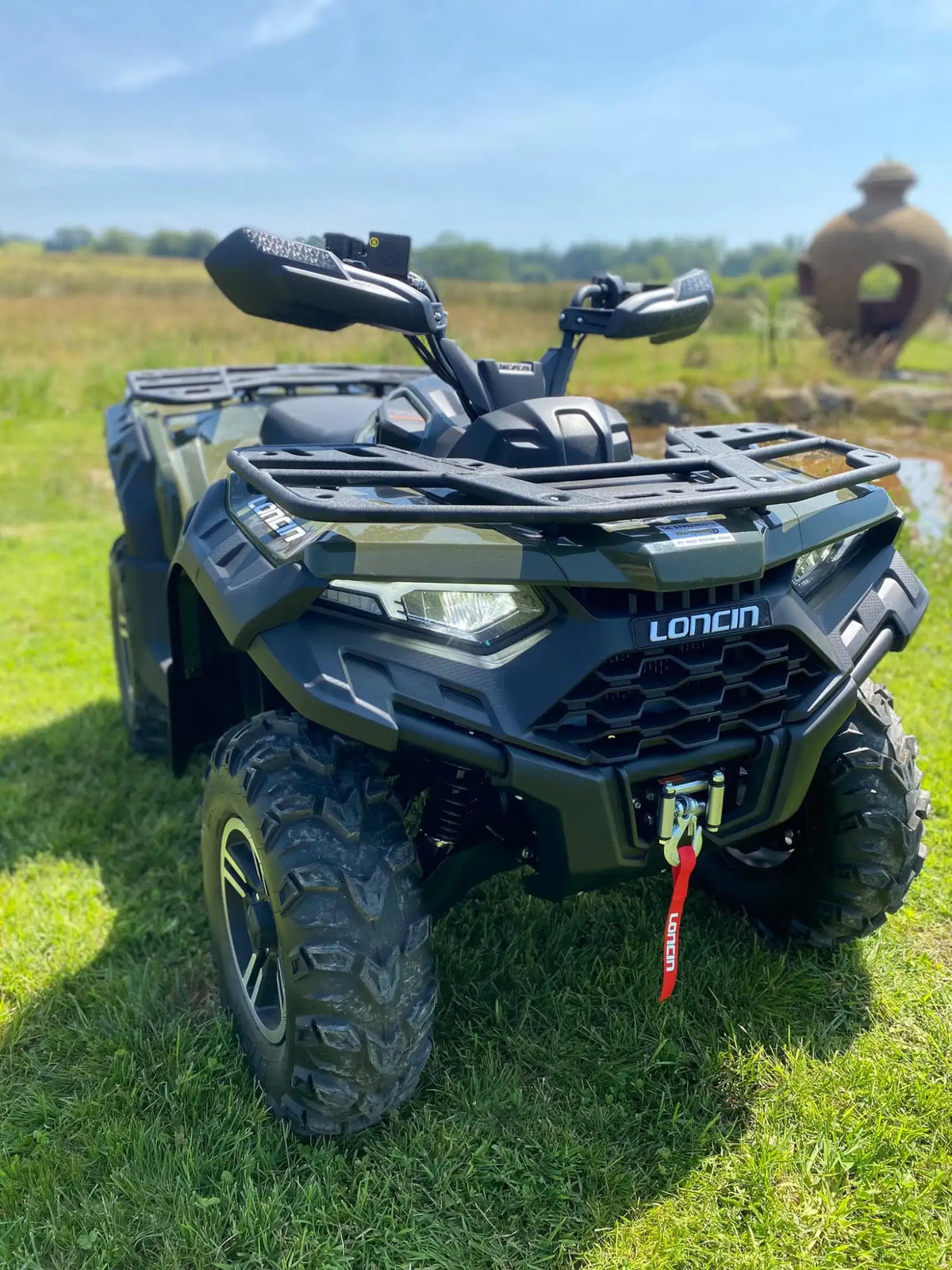 Black loncin quad bike with rugged off-road tires and a front rack.