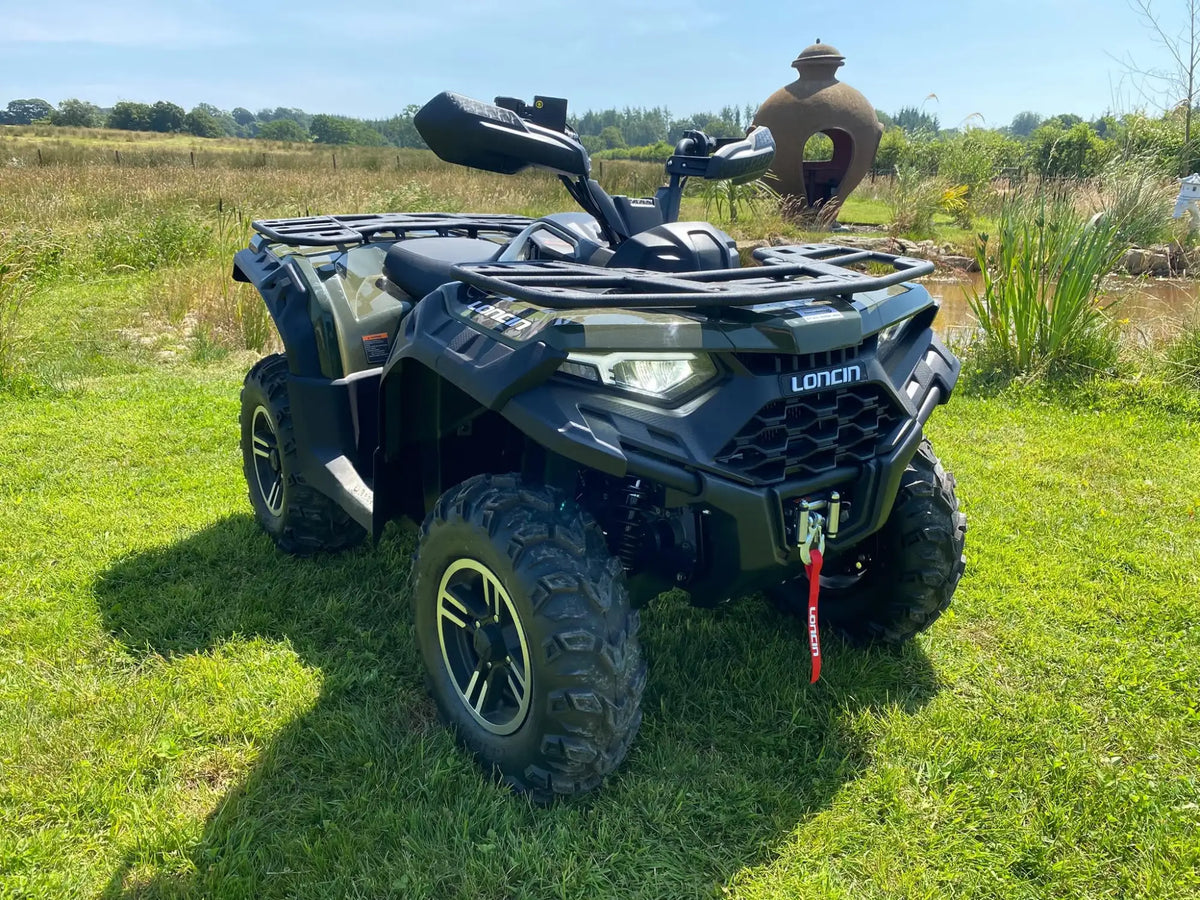 Black and olive green loncin atv with rugged tires, black alloy wheels, and a front rack.